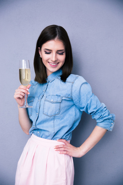 Smiling young woman holding glass of champagne - Fotó, kép