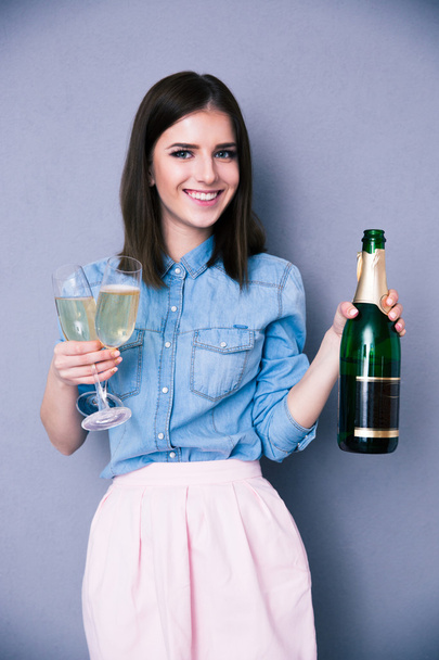 Woman holding two glass and bottle of champagne - Φωτογραφία, εικόνα