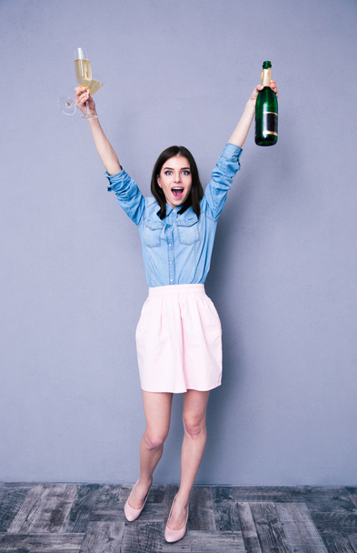 Woman holding two glass and bottle of champagne - Foto, Bild