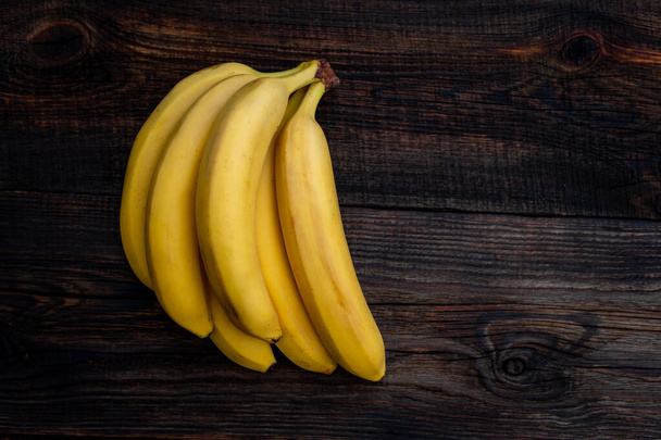 Some bananas on a white wooden table. Empty copy space for editor's text. - Photo, Image