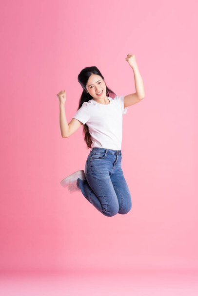Full body image of Asian girl posing on pink background - Photo, Image