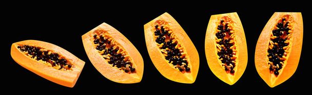 Papaya ripe fruit isolated with clipping path in black background, no shadow, healthy tropical fruit, half and slice, piece - Photo, Image