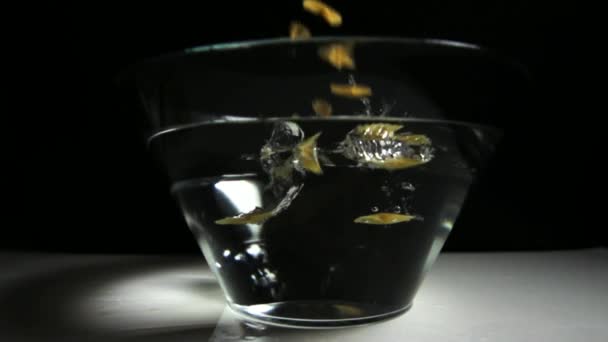 Pasta dropping in bowl with water - Footage, Video
