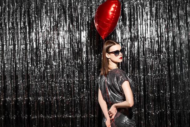Glamour fashion young woman holding a heart balloon. Valentine's day concept. Copy space - Photo, Image