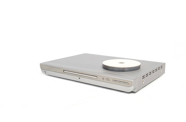 Silver colored dvd or cd player with several discs placed on top. - Photo, Image