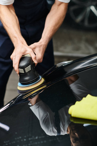 cropped view of hard working professional serviceman using polishing machine on black modern car - Photo, Image