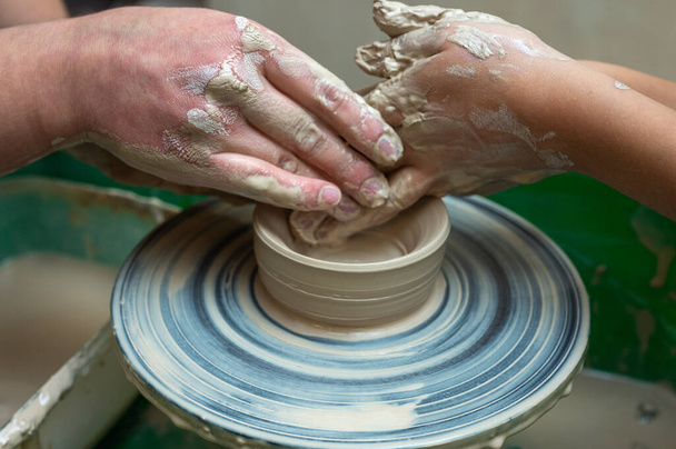 Глина, кераміка або руки в дизайнерській майстерні, що працює над художньою чашкою або чашкою форми в невеликій бізнес-студії. Рука творчого художника або працівника виробництва ремесел у скульптурі - Фото, зображення