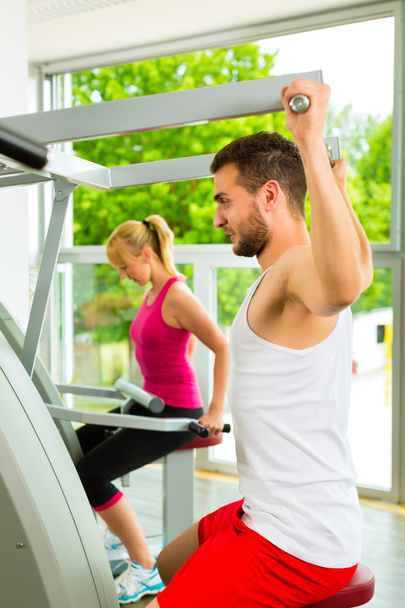 People in sport gym on the fitness machine - Photo, Image