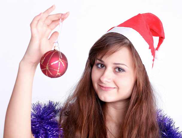 Attractive young girl with christmas presents wondering - 写真・画像