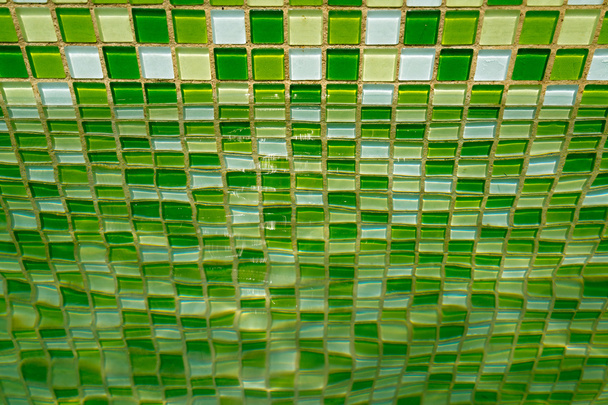 Green mosaic tile on the wall of a swimming pool - Photo, Image