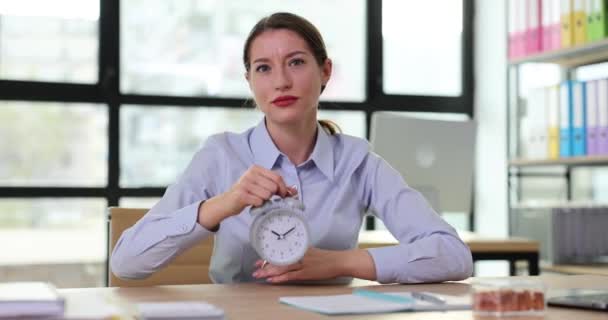 Dissatisfied woman boss points finger to alarm clock hinting corporate worker about late. Incorrect management of time and punishment from executive - Footage, Video