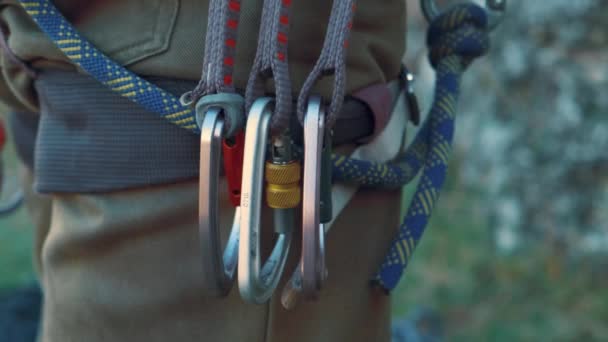 Close up video of safety carabiners and brakes on climber man hips. - Footage, Video