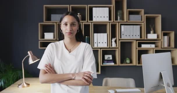 Serious, crossed arms and face of woman in office with creative career for planning at designing agency. Professional, confident and portrait of female designer standing by desk in modern workplace - Footage, Video