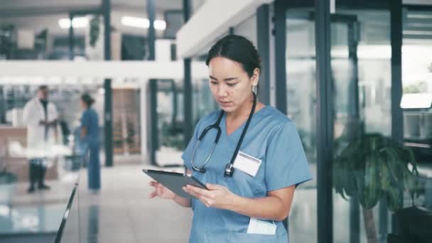 Asian woman, doctor and tablet for research, communication or networking at hospital. Young female person or medical nurse with technology for online search, social media or Telehealth at clinic. - Footage, Video