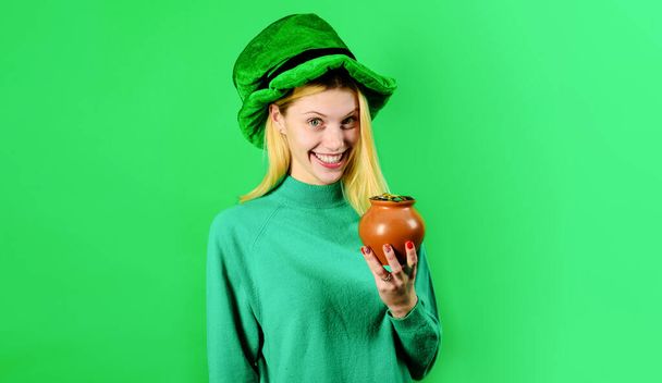 Happy Patricks day. Pot of money for Patricks day party. Smiling woman in Leprechaun green hat with pot of gold. Traditions of Saint Patrick Day. Blonde girl with pot of coins in leprechaun costume - Photo, Image
