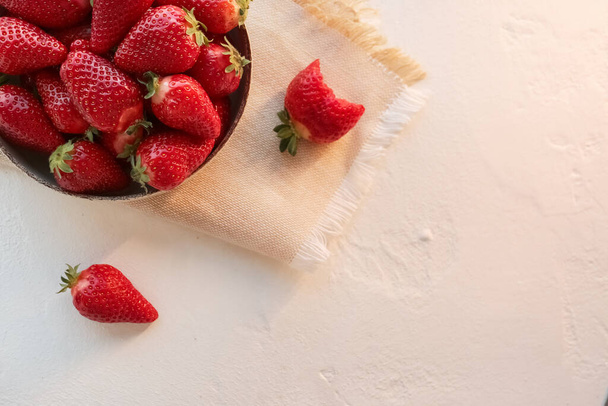 Bowl with fresh strawberries on white background - Photo, Image