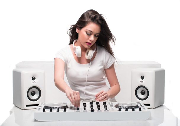 Trendy sexy DJ dressed in white mixing music - Photo, Image