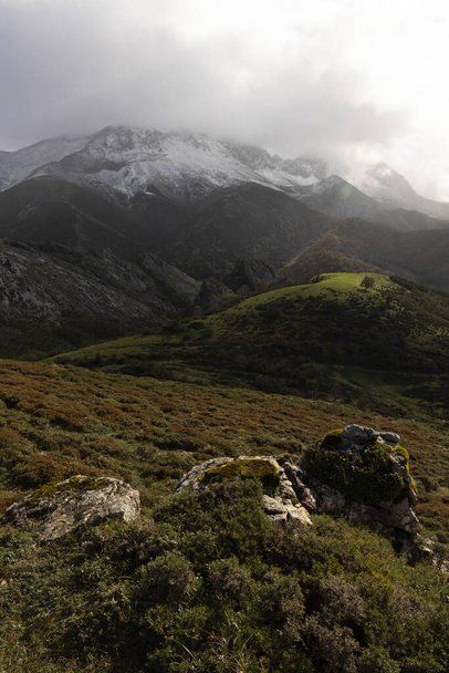 Panoramic landscape of natural park in northern Spain Cantabrian mountain range with peaks and autumn forest on a cloudy overcast day at sunset - Photo, Image