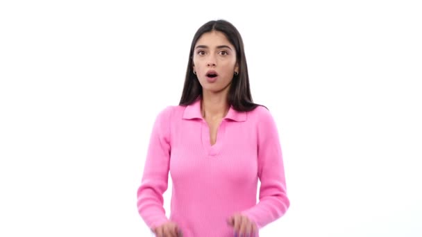 Young woman displays a startled expression, reflecting a sudden sense of apprehension against a clean white background. This image conveys raw and genuine emotion . - Footage, Video