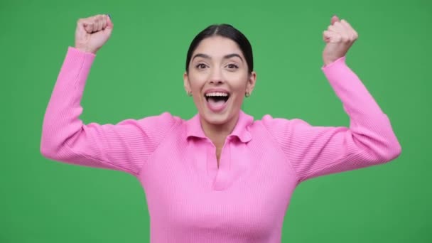 Contented Caucasian woman expresses delight by exclaiming Wow and applauding with joy. Scene filled with positivity and appreciation over green background. - Footage, Video