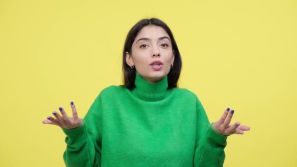 Positive Caucasian blogger enthusiastically encourages viewers with gestures of Subscribe and Like. Yellow background creating a visually engaging scene filled with positivity and interactive charm. - Footage, Video
