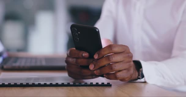Business person, hands and phone at desk in office for social network, mobile chat and contact in company. Closeup, employee and typing on smartphone, scroll digital news app and search internet. - Footage, Video