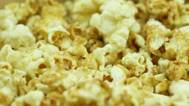 Slow motion and rotates popcorn. Yellow fresh salted popcorn texture circle rotation close up - Footage, Video