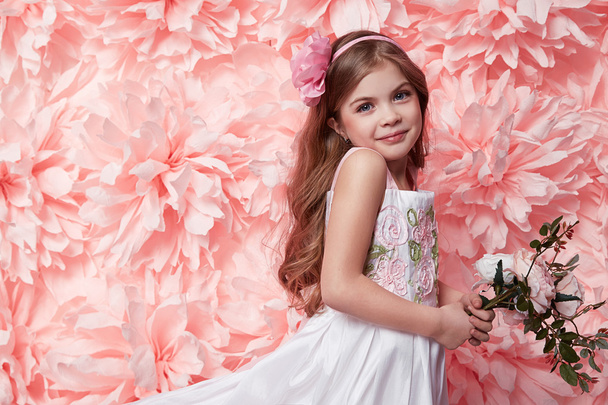 Beautiful little girl in cute dress with flower - Zdjęcie, obraz