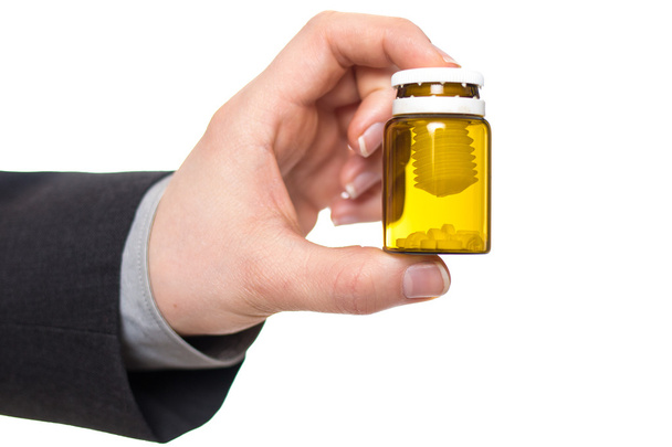 Pills in a small yellow jar - Photo, Image