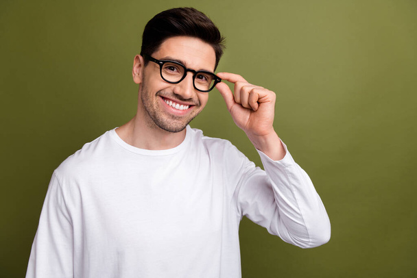 Portrait of optimistic businessman trying trendy eyeglasses and showing new style accessory optics isolated on khaki color background. - Zdjęcie, obraz