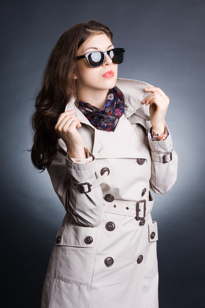 Beautiful woman in the raincoat and sunglasses - Фото, зображення