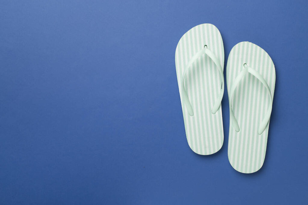 Striped flip flops on color background, top view - Photo, Image