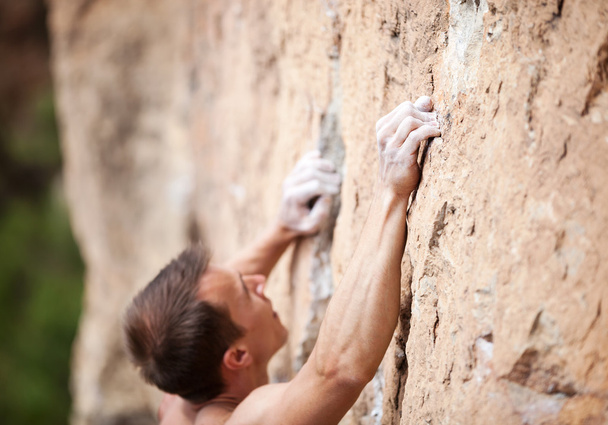 Cropped view of male rock climber on cliff - Photo, Image