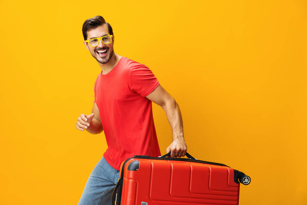Weekend man background yellow suitcase space trip journey baggage guy vacation copy holiday hipster travel yellow lifestyle ticket flight happy traveler studio - Fotoğraf, Görsel