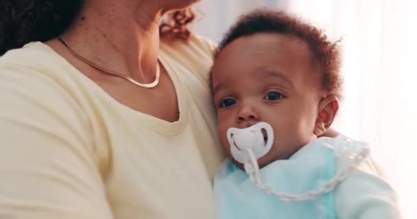 Cute, bonding and mother holding baby with pacifier for calming with love and care at family home. Trust, embracing and closeup of mom carrying sweet boy infant, child or newborn in modern house - Footage, Video