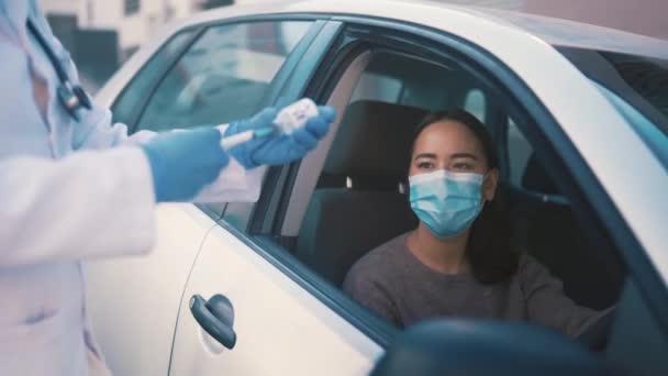 Doctor, car and woman with vaccine vial for injection, booster shot or covid disease protection, safety or security. Medicine, health support and nurse with immunization syringe for patient driver. - Footage, Video