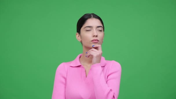 Contemplative caucasian woman is captured in a moment of inspiration as a brilliant idea strikes. Creativity and newfound insight filled air over green background. - Footage, Video