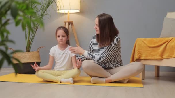 Fitness and playtime. Wellness practices for kids. Active play and health. Caucasian woman and her charming little daughter doing yoga together mother teaching kid to do sports exercises - Filmagem, Vídeo