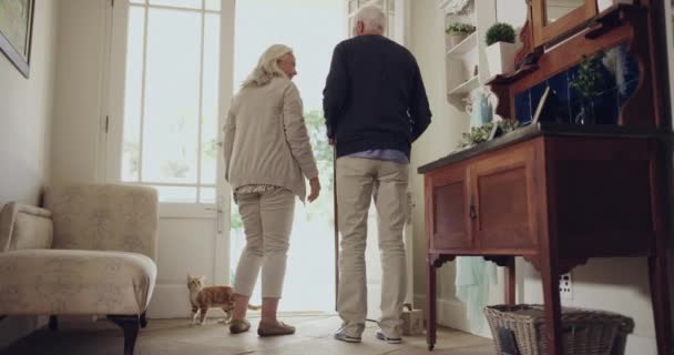 Senior couple, front door and leaving home for walk, together and ready for outdoor activity. Elderly people, bonding and person with a disability in marriage, cane and enjoying retirement or back. - Footage, Video