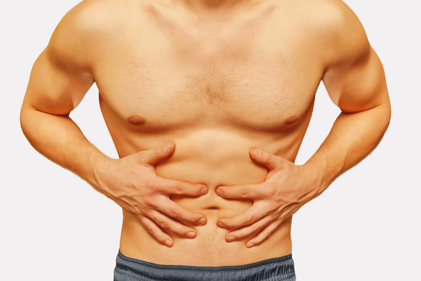 Man compresses abdomen with pain - Fotó, kép