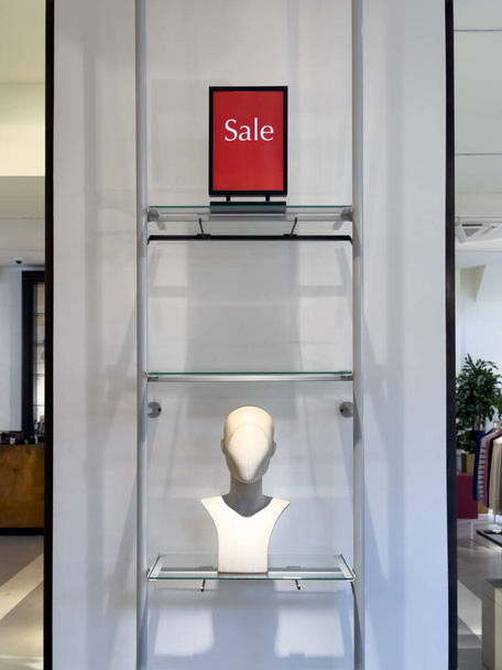 January sale sign and mannequin in shop, vibrant red signs showcase exciting discounts, drawing shoppers to explore and seize the fantastic deals. - Photo, Image