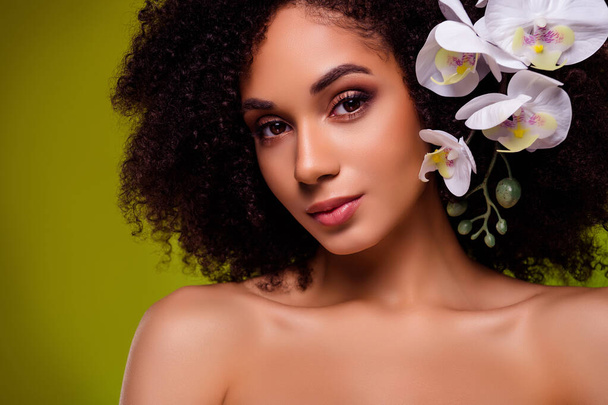 Photo of gorgeous girl floral princess with orchid in curls enjoy organic beauty product over green background. - Photo, Image