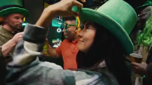 Images POV d'une jolie femme Biracial en chapeau vert faisant la fête avec des amis en club avec de l'alcool célébrant la Saint-Patricks - Séquence, vidéo