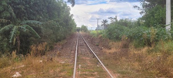 Bulutlu bir günde doğanın ortasında tren yolu - Fotoğraf, Görsel