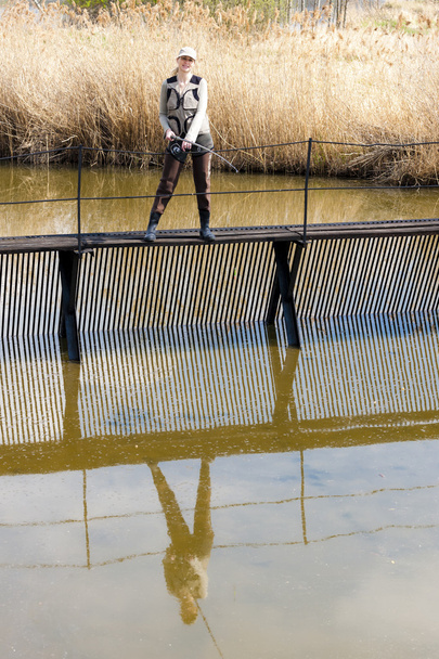 Woman fishing on pier - Photo, Image