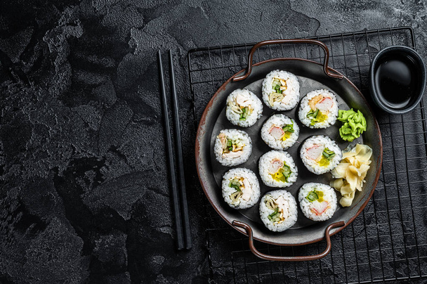 Kimbap gimbap filled with vegetables, egg, eanchovy and crab, Korean rice roll. Black background. Top view. Copy space. - Photo, Image