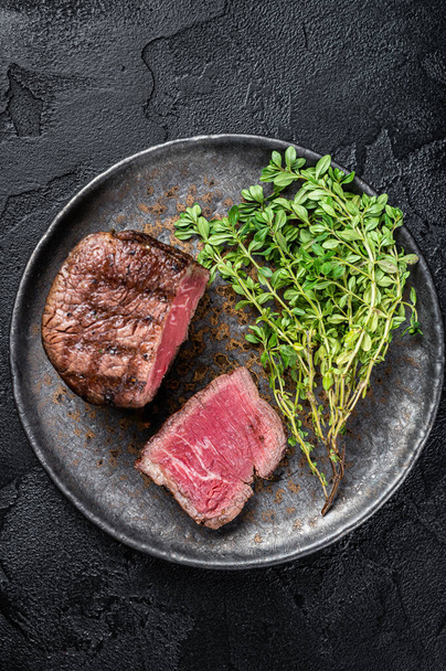 Prime Fillet Mignon Steaks, grilled beef tenderloin meat. Black background. Top view. - Fotografie, Obrázek