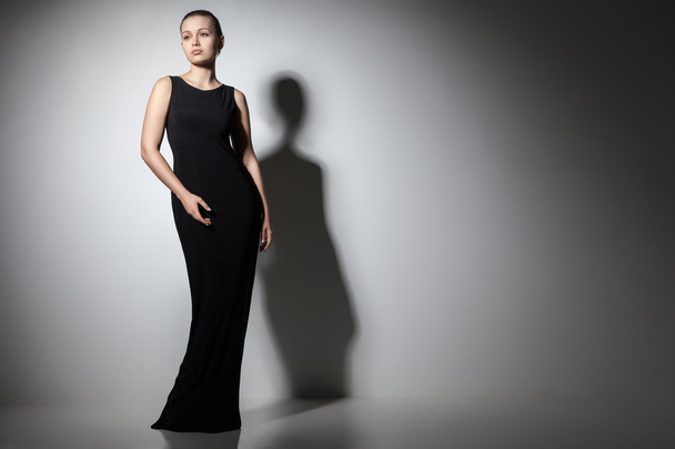 beautiful woman model posing in elegant black dress - Fotó, kép