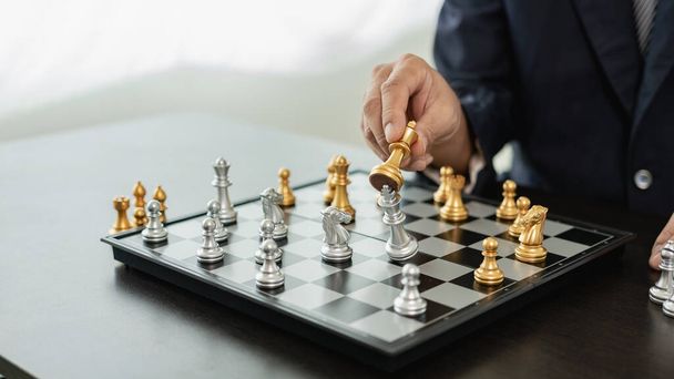 Close up of chess game with hands analyzing new strategy plan, teamwork concept, hands of businessman moving chess pieces in successful competition. Management strategy or leadership concept - Photo, Image