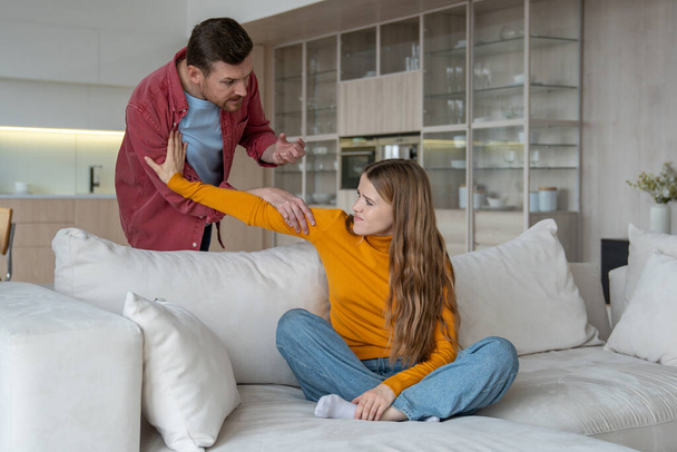 Heated home quarrel offended upset woman pushes angry man away moment of emotional turmoil. Family dispute, scandal intensity disagreement, struggle to find common ground in difficulties relationship - Photo, Image